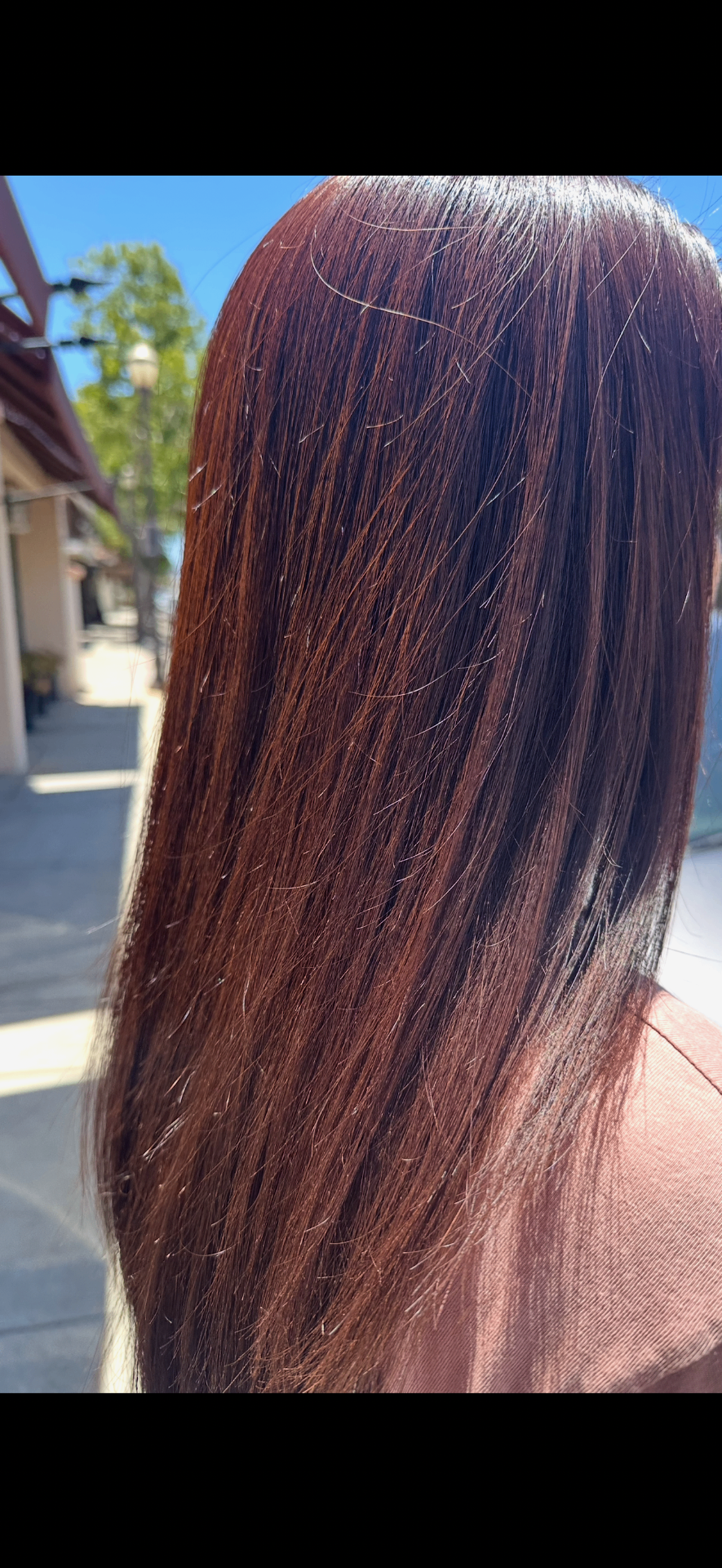 Vibrant deep auburn on long straight hair
