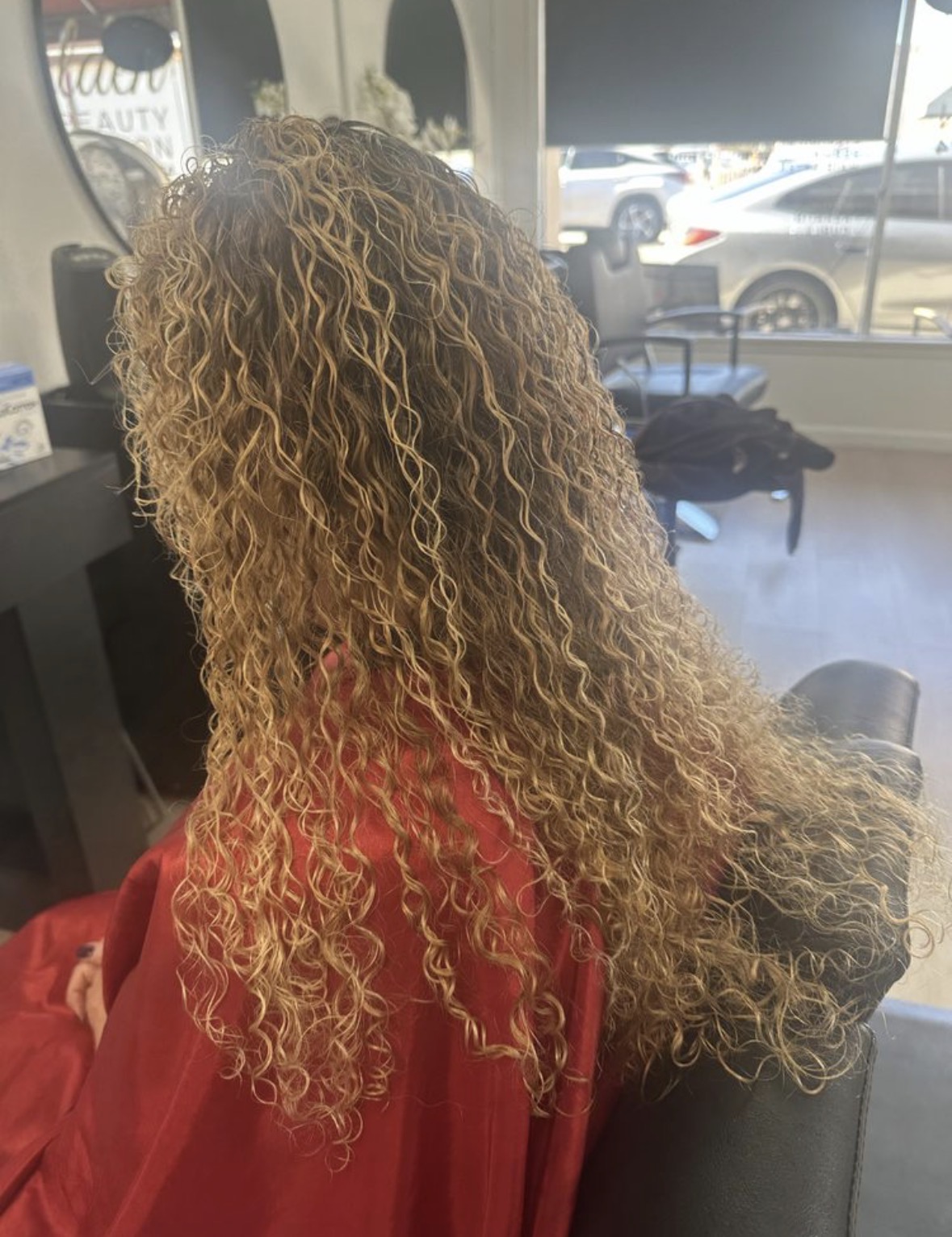 Golden blonde curls styled at Golden Age Beauty Salon