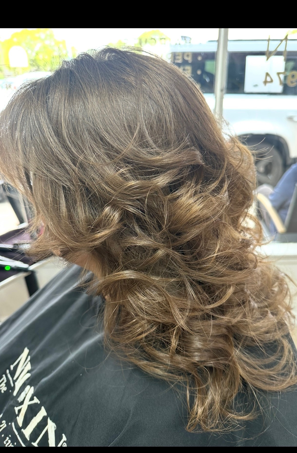 Soft brunette curls with caramel highlights