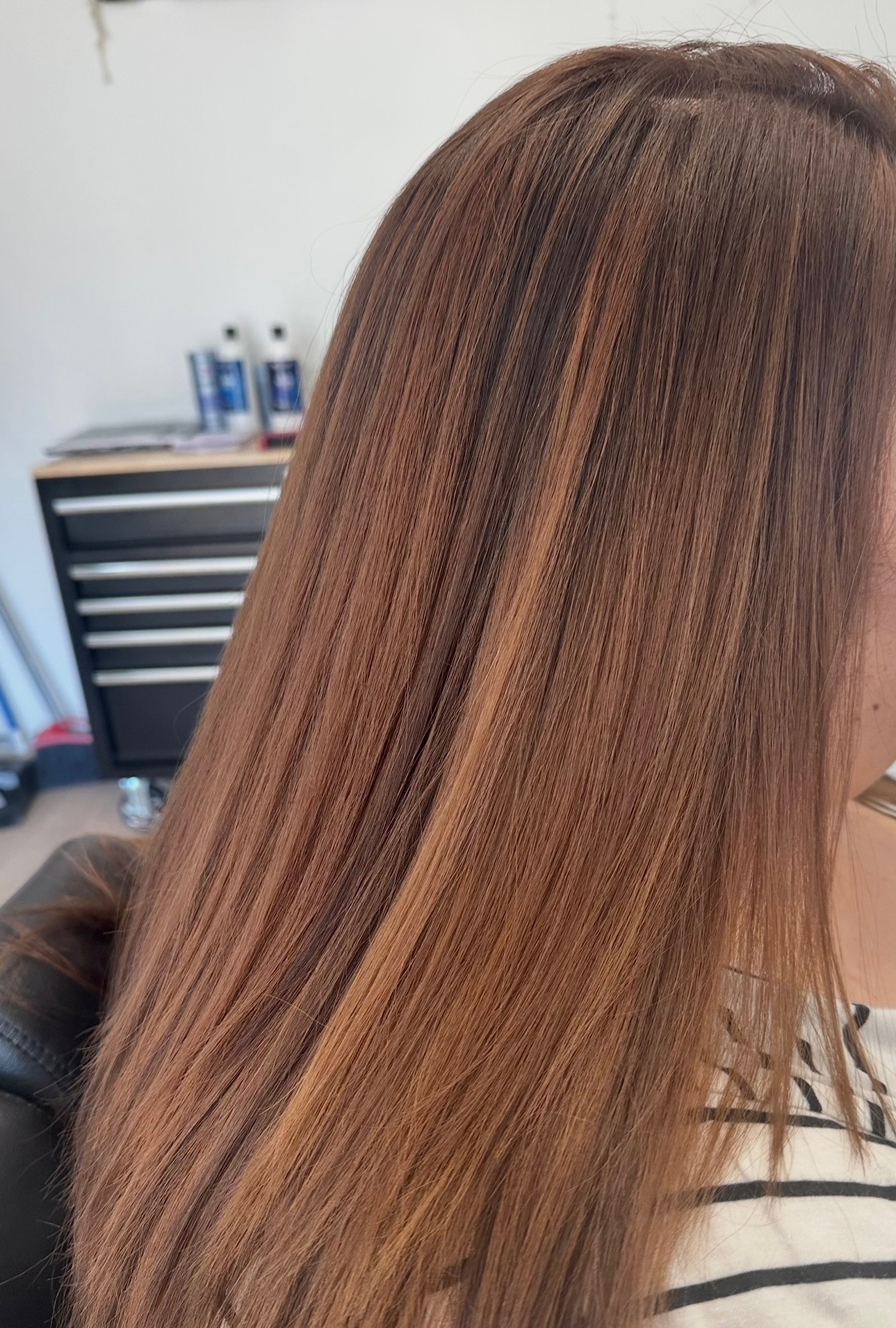 Warm auburn balayage on long straight hair